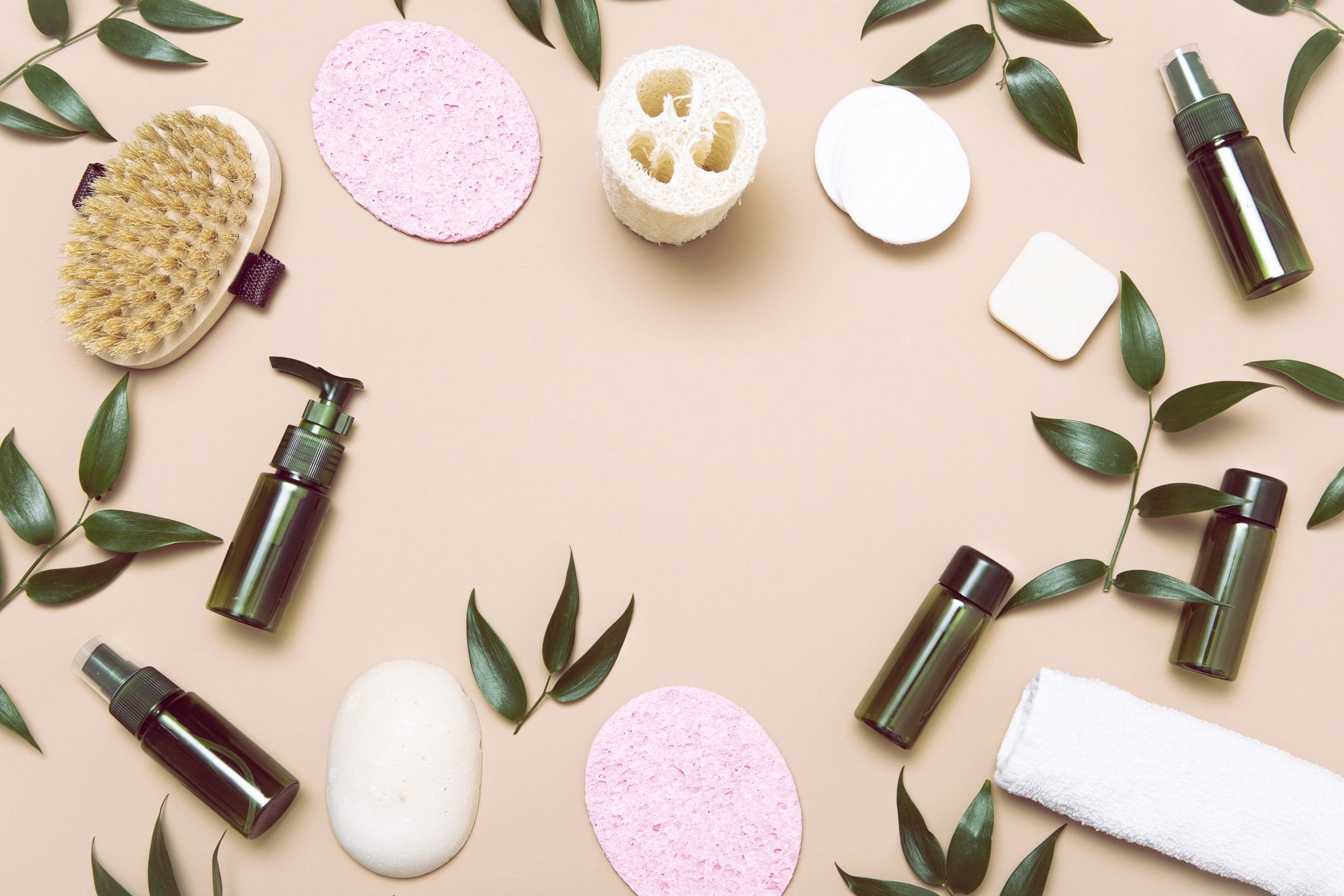 Minimal flat lay of organic wellness products on a soft green background