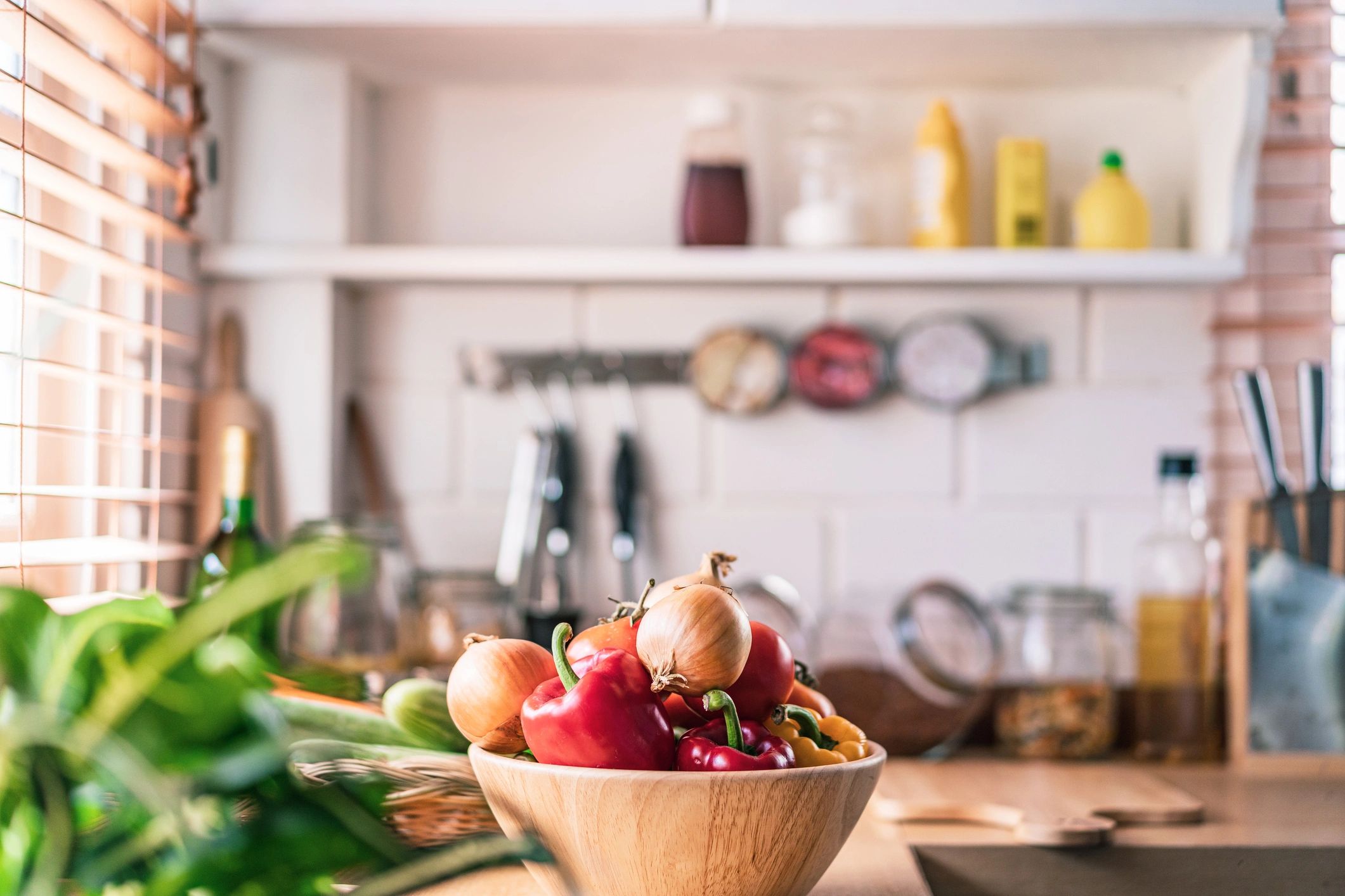 Sunlit kitchen with fresh vegetables on the counter